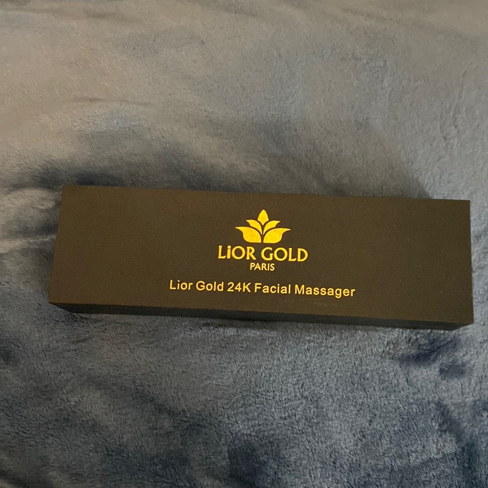 Golden face massager never been used.